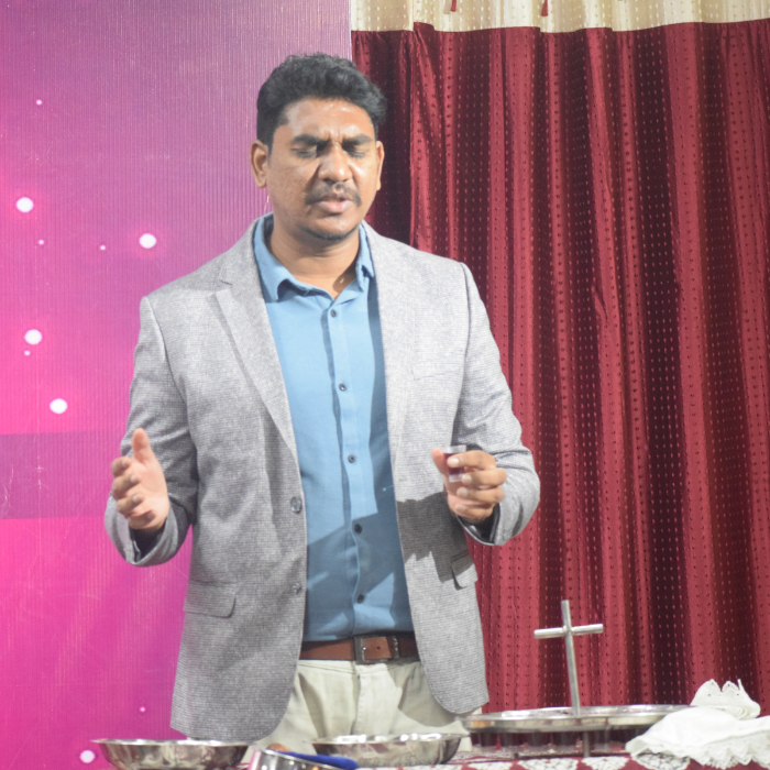 Dr Stephen Bob Praying in Communion Service